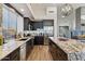 Modern kitchen with granite countertops and dark cabinetry at 34476 N 68Th Way, Scottsdale, AZ 85266