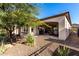 Covered patio and backyard with gravel and desert landscaping at 36038 N Puente Alto Ave, Queen Creek, AZ 85140