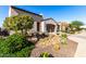 Landscaped front yard with drought-tolerant plants and a brick driveway at 36038 N Puente Alto Ave, Queen Creek, AZ 85140