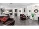 Open concept living area with leather seating and a view into the kitchen at 36038 N Puente Alto Ave, Queen Creek, AZ 85140