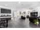 Open concept living room with dark leather furniture and tile floors at 36038 N Puente Alto Ave, Queen Creek, AZ 85140