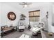 Relaxing sitting room with comfy chairs, guitar, and large mirror at 36038 N Puente Alto Ave, Queen Creek, AZ 85140