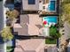 Stunning aerial view of a private backyard oasis with a sparkling pool and vibrant red umbrella at 3933 E Alfalfa Dr, Gilbert, AZ 85298