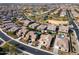 Expansive aerial view of a desert neighborhood featuring lush green spaces and community lakes at 3933 E Alfalfa Dr, Gilbert, AZ 85298