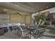 Relaxing covered patio featuring an outdoor dining and seating area with view of the yard at 3933 E Alfalfa Dr, Gilbert, AZ 85298