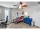 A bedroom featuring a desk, bed with plaid bedding, and a window with blinds at 3933 E Alfalfa Dr, Gilbert, AZ 85298