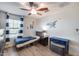 A bedroom featuring a bed with blue bedding, a dresser, and striped curtains at 3933 E Alfalfa Dr, Gilbert, AZ 85298