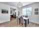 Bright dining area features a modern chandelier, gray chairs, and a marble table, perfect for Gathering meals and entertaining at 3933 E Alfalfa Dr, Gilbert, AZ 85298