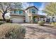 Charming two-story home featuring a covered front porch and brick-paved driveway at 3933 E Alfalfa Dr, Gilbert, AZ 85298