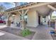 Welcoming front porch featuring stone pillars, covered seating area, and beautiful brick pavers at 3933 E Alfalfa Dr, Gilbert, AZ 85298