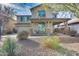 Inviting two-story home featuring a covered porch, desert landscaping, and a two-car garage at 3933 E Alfalfa Dr, Gilbert, AZ 85298