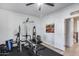 A home gym featuring a weight bench with a bar, weights, and black rubber flooring at 3933 E Alfalfa Dr, Gilbert, AZ 85298