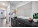 A hallway featuring a serving area with decorations and a view into the bathroom at 3933 E Alfalfa Dr, Gilbert, AZ 85298