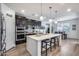 Modern kitchen with black cabinets, quartz countertops and stainless steel appliances at 3933 E Alfalfa Dr, Gilbert, AZ 85298