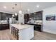 Modern kitchen with stainless steel appliances, dark cabinets, and a quartz countertop island at 3933 E Alfalfa Dr, Gilbert, AZ 85298