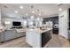 Open concept kitchen with stainless appliances, dark cabinetry, and island, flowing to living area at 3933 E Alfalfa Dr, Gilbert, AZ 85298