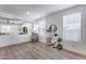 Bright living room with wood floors, decor, and plenty of natural light from the windows at 3933 E Alfalfa Dr, Gilbert, AZ 85298