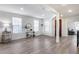 Bright living room with wood floors and plenty of natural light from the windows at 3933 E Alfalfa Dr, Gilbert, AZ 85298