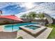 Backyard pool and spa combination, with a waterfall feature and ample deck space at 3933 E Alfalfa Dr, Gilbert, AZ 85298