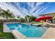 Beautiful backyard with a sparkling pool, spa, mature trees, and lounging area at 3933 E Alfalfa Dr, Gilbert, AZ 85298