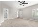 Light-filled bedroom featuring carpet, ceiling fan and access to bathroom at 4041 E Lexington Ave, Gilbert, AZ 85234