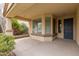 Covered front porch with a door and bay window, featuring a stone planter at 4041 E Lexington Ave, Gilbert, AZ 85234