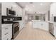 Modern kitchen featuring white cabinets, stainless steel appliances, and a large island at 4041 E Lexington Ave, Gilbert, AZ 85234