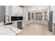 Modern kitchen with white cabinets, quartz countertops, and a black tile backsplash at 4041 E Lexington Ave, Gilbert, AZ 85234