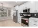 Updated kitchen featuring stainless steel appliances and white cabinetry at 4041 E Lexington Ave, Gilbert, AZ 85234