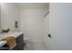 Modern bathroom with dark vanity, hexagon tile, and shower at 4056 E Rosemonte Dr, Phoenix, AZ 85050