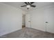 Spacious bedroom with ceiling fan and access to hallway at 4056 E Rosemonte Dr, Phoenix, AZ 85050