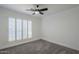 Bright bedroom with ceiling fan and plantation shutters at 4056 E Rosemonte Dr, Phoenix, AZ 85050