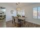 Charming dining room with a rustic wood table and chandelier at 4056 E Rosemonte Dr, Phoenix, AZ 85050