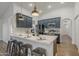 Kitchen island with white quartz countertop and industrial-style stools at 4056 E Rosemonte Dr, Phoenix, AZ 85050