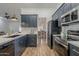 Modern kitchen with stainless steel appliances and dark blue cabinetry at 4056 E Rosemonte Dr, Phoenix, AZ 85050