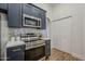 Stylish kitchen with dark cabinets and modern range at 4056 E Rosemonte Dr, Phoenix, AZ 85050