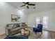 Living room with gray sofa, blue chairs, and a gold coffee table at 4056 E Rosemonte Dr, Phoenix, AZ 85050