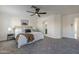 Main bedroom with ceiling fan, plush carpet, and ensuite bathroom access at 4056 E Rosemonte Dr, Phoenix, AZ 85050