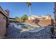 Relaxing kidney-shaped pool surrounded by rocks and a paved patio at 4056 E Rosemonte Dr, Phoenix, AZ 85050