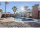 Inviting kidney-shaped pool with brick patio and rock landscaping at 4056 E Rosemonte Dr, Phoenix, AZ 85050