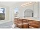 Bathroom with wood vanity, large mirror, and window at 4079 E Yucca St, Phoenix, AZ 85028