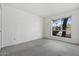 Well-lit bedroom featuring carpeted floors and a window at 4079 E Yucca St, Phoenix, AZ 85028