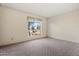 Bright bedroom with carpeted floor and large window at 4079 E Yucca St, Phoenix, AZ 85028