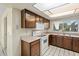 View of kitchen with wood cabinets and white appliances at 4079 E Yucca St, Phoenix, AZ 85028