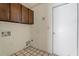 Laundry room with wooden cabinets and tiled floor at 4079 E Yucca St, Phoenix, AZ 85028