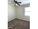 Spacious bedroom with ceiling fan and carpet at 42025 W Manderas Ln, Maricopa, AZ 85138