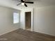 Bedroom with ensuite bathroom access and ceiling fan at 42025 W Manderas Ln, Maricopa, AZ 85138