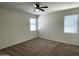 Well-lit bedroom with two windows and ceiling fan at 42025 W Manderas Ln, Maricopa, AZ 85138