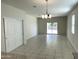 Bright dining area with tile floors and sliding glass doors to patio at 42025 W Manderas Ln, Maricopa, AZ 85138