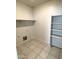 Laundry room with shelving and tile floors at 42025 W Manderas Ln, Maricopa, AZ 85138